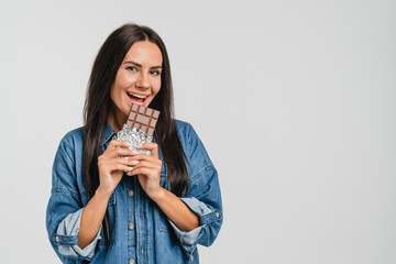 Teeth dental problems. Tooth decay, acne. Unhealthy junk food. Woman girl wants to eat chocolate bar with calories, saturated fats, gaining weight while dieting on sweets isolated in white background.