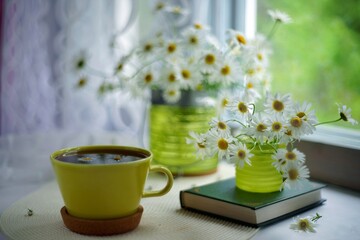 cup of tea and flowers on wooden table