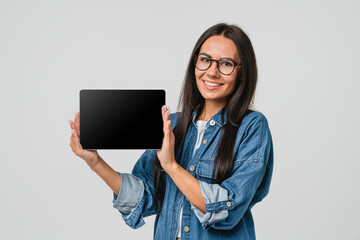 Smart caucasian young woman holding showing digital tablet blank screen for mockup copy space with...
