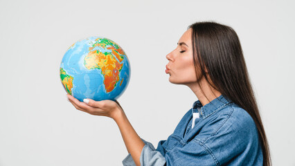 Geography concept. Caucasian young woman eco-activist hugging embracing kissing Earth globe with care, protecting planet from contamination, garbage, traveling abroad isolated in white background