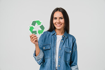 Young caucasian woman girl eco-activist holding recycling logo sign for sorting garbage paper...