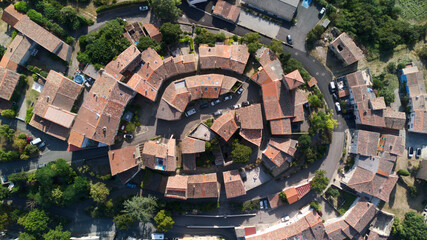 Aerial shot of a medieval round Bellegarde-du-Razes village with red roofs in South of France