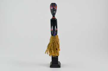 a statuette of an.wooden vintage figurine on a white background.