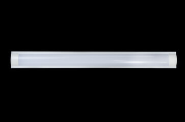 Long modern LED lamp with plastic housing isolated on black background