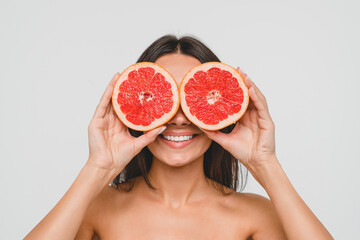 Happy caucasian young pretty woman lady female holding grapefruit for healthy eating dieting,...