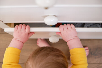 Danger for the baby to pinch the hand of the cabinet door or chest of drawers. Protect children...