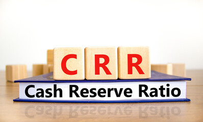 CRR cash reserve ratio symbol. Concept words CRR cash reserve ratio on wooden cubes on book on a...
