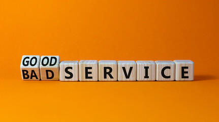 Good or bad service symbol. Turned wooden cubes and changed words bad service to good service. Beautiful orange table orange background. Business good or bad service concept, copy space.