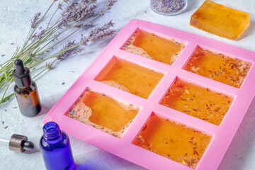 Soap making. Liquid glycerin with natural additives in a silicone mould