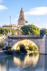 Vertical shot of a historic bridge and cathedral tower in Murcia, Spain