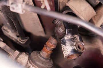 Close-up of the rusty splines and the steering shaft gimbal under the hood of the car. Car repair and maintenance.