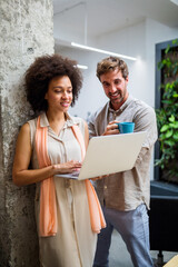 Happy business people having fun and chatting at workplace office. Flirting at work