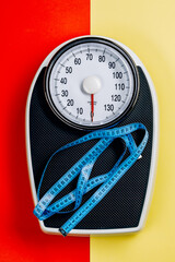 Scales and measuring tape. top view. the concept of excess weight.