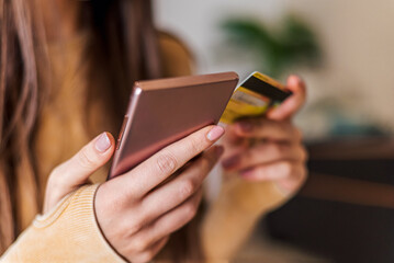 Close up shot of a mobile phone, purchasing with credit card.