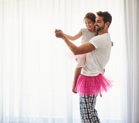Dancing with her father. Cropped shot of a handsome young man and his daughter dancing at home.