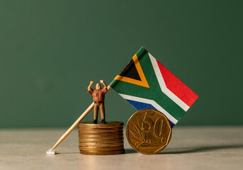 South African coins and a flag.  Miniature man on the coin.