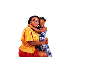 portrait of a pretty little girl hugging her mom, smiling.
