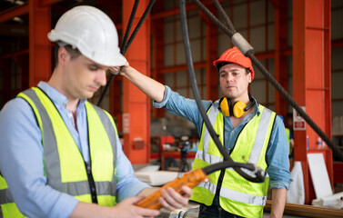 Two young engineers Testing and checking the operation of the semi gantry crane