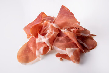Slices of Parma ham (Italian prosciutto crudo) isolated on white background