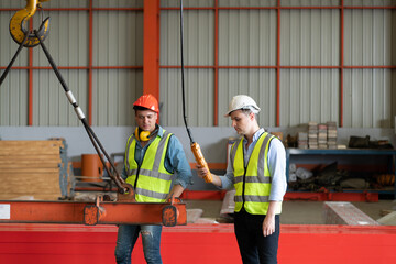 Two young engineers Testing and checking the operation of the semi gantry crane - obrazy, fototapety, plakaty