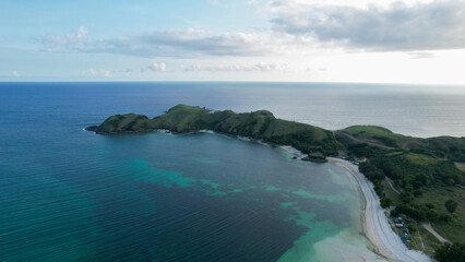 Aerial view of Tanjung Aan, Tropical island with sandy beach and turquoise ocean with waves. Lombok. Indonesia, Mach 22, 2022