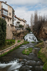 Waterfalls of the Cifuentes river flowing through the Spanish village of Trillo