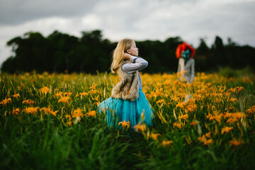 Female strong child is courageous with monster orange flower field