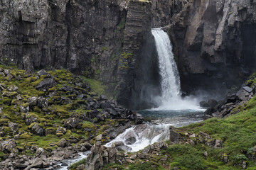 Fototapeta na wymiar Closeup of beautiful landscape with a waterfall on a small mountain river in Iceland