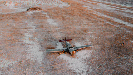 Closeup of a plane parked in a snowy field