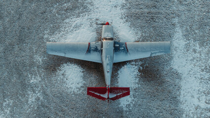 Top view of a plane parked in a snowy field