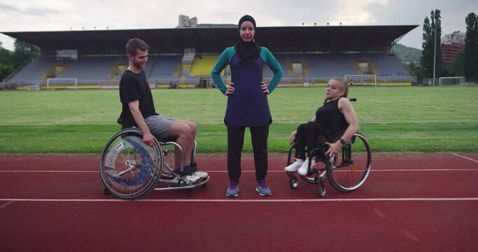 Hero portrait shot of Person with a disability whit female trainer wearing hijab after training on athletics sports track. 