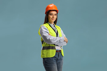 Young female site engineer with a safety vest and hardhat