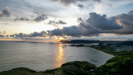 Aerial view of Tanjung Aan, Tropical island with sandy beach and turquoise ocean with waves....