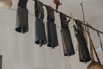 Closeup of metal cowbells hanging on a wire