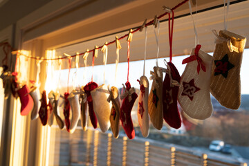Closeup shot of advent stockings hanging near a window