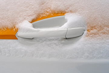 Handle of a taxi car in snow winter season. Close up