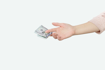 Close-Up Of Hand Holding Paper Currency Against White Background