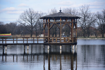 Closeup of a gazebo on a wooden bridge in the park