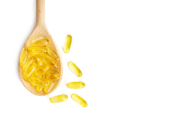 Pile of softgels capsules Omega 3 in wooden spoon isolated on white background. Close up, top view, flat lay with copy space