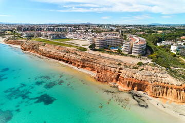 Aerial shot Dehesa de Campoamor townscape with sandy beach. Spain - obrazy, fototapety, plakaty