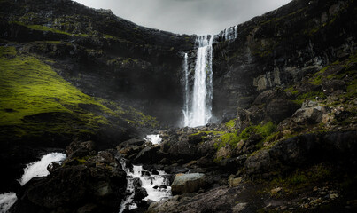 Fototapeta na wymiar Stunning view of Fossa Waterfall on the eastern cost of Streymoy Island. Fossa is the largest waterfall in the Faroe islands.