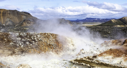 Beautiful shot of a natural geyser in mountains.
