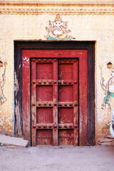 21 March 2022, Pandharpur, India, Old Vintage wooden door on retro wall, Pandharpur, India.