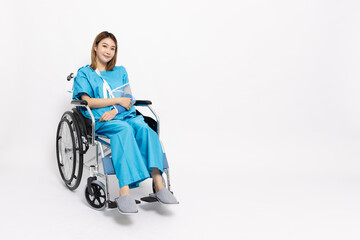 Young Asian woman sitting on wheelchair and wearing patient outfits and put on a soft splint due to...