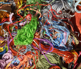 Close up view into a basket with colourful darning cotton.