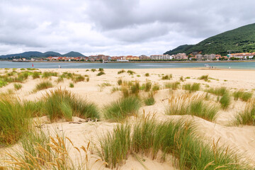 Fototapeta na wymiar View of Santoña from El Puntal and beach with Laredo dunes in Cantabria, Spain 