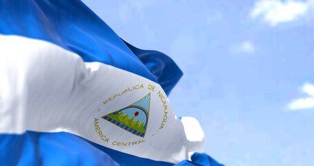 Detail of the national flag of Nicaragua waving in the wind on a clear day