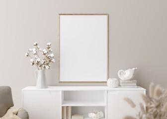 Empty vertical picture frame on cream wall in modern living room. Mock up interior in minimalist, scandinavian style. Free, copy space for picture. Console, armchair, cotton plant, vase. 3D rendering.