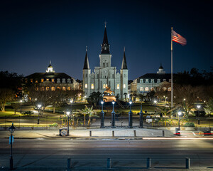 Night shot of buildings and the Flag of the USA in New Orleans