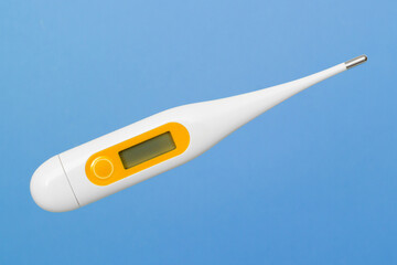 Oral medical thermometer on blue